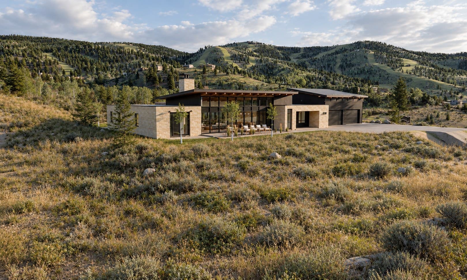 The new home's north front with the ski mountain behind on a summer evening
