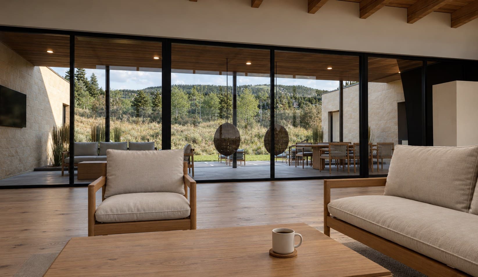 Great room of the new home looking south through a wall of glass at a summer evening